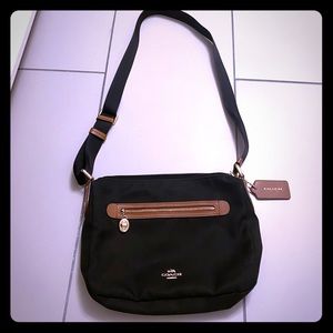 Black crossbody coach purse with brown and gold